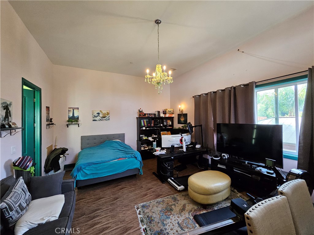 9740 La Canada Way Shadow Hills, CA 91040 - Photo 11 of 28 a living room with furniture a flat screen tv and a floor to ceiling window