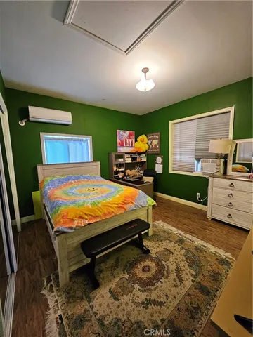 a room with pool table and a wooden floor