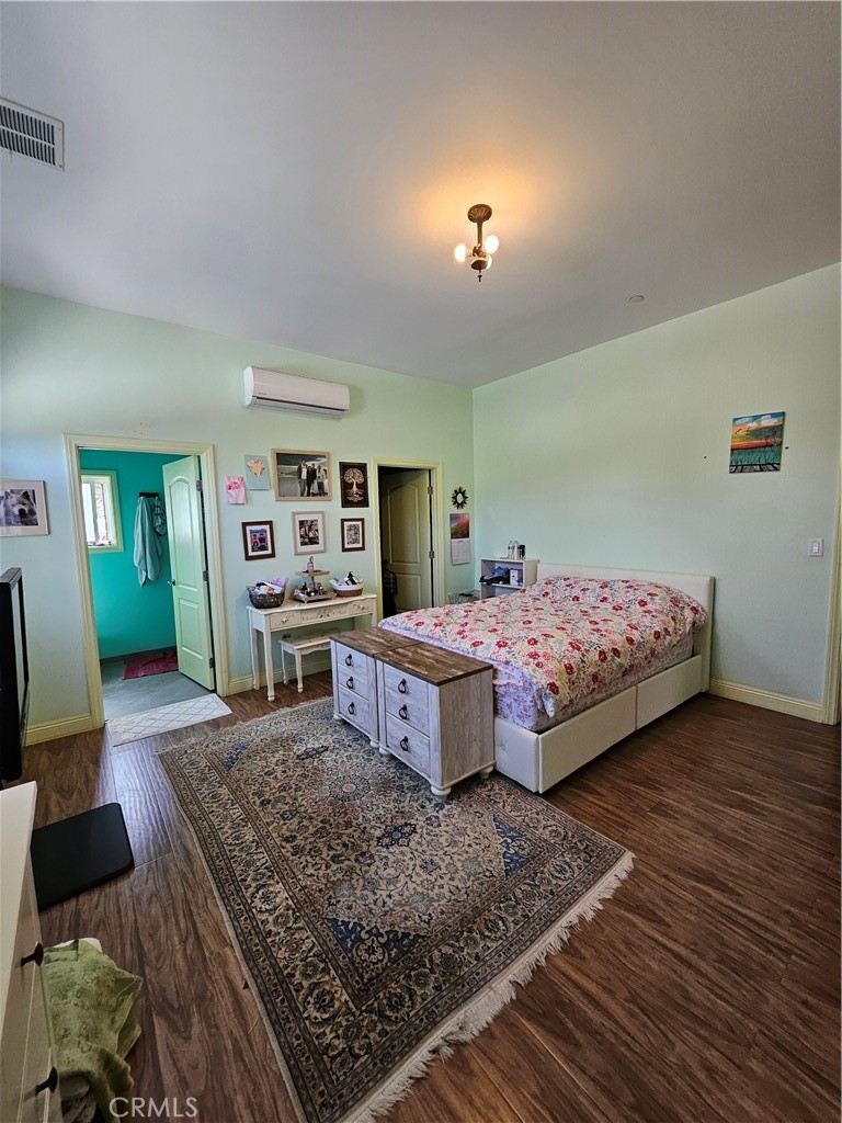9740 La Canada Way Shadow Hills, CA 91040 - Photo 12 of 28 a bedroom with a bed and wooden floor