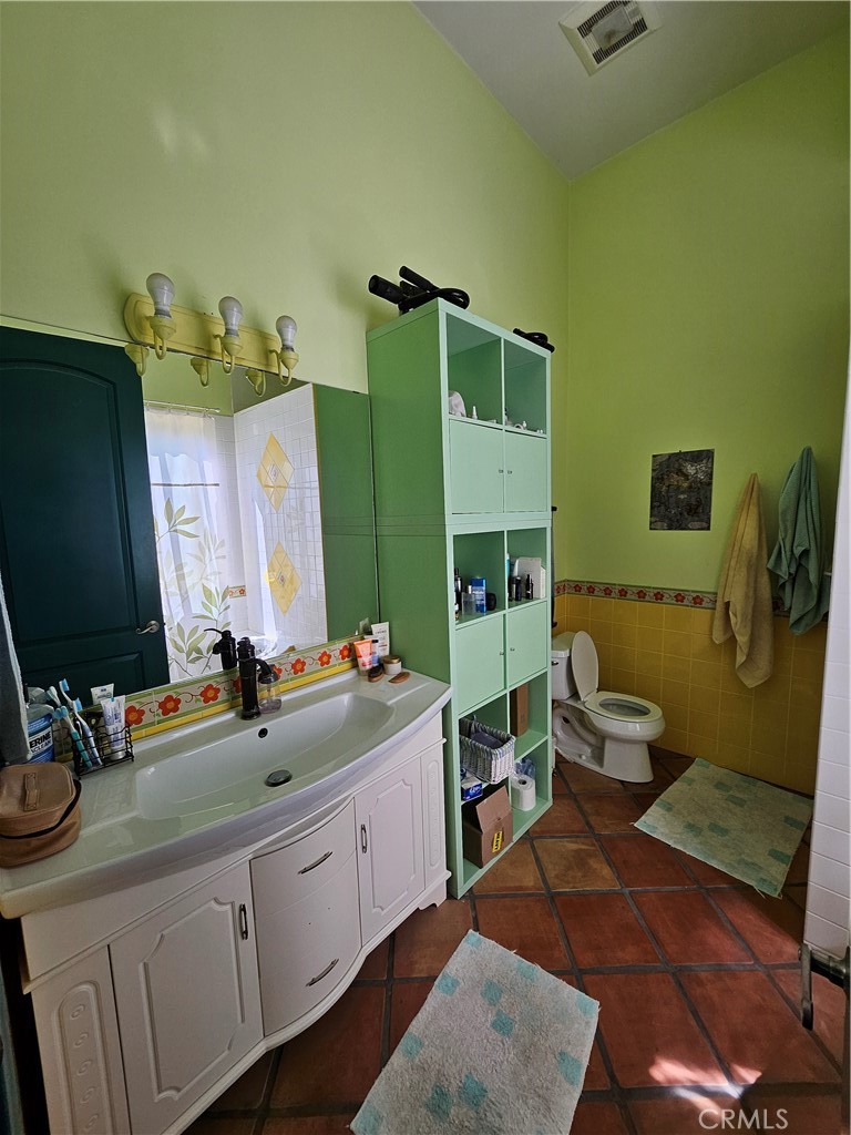 9740 La Canada Way Shadow Hills, CA 91040 - Photo 14 of 28 a bathroom with a sink mirror and toilet
