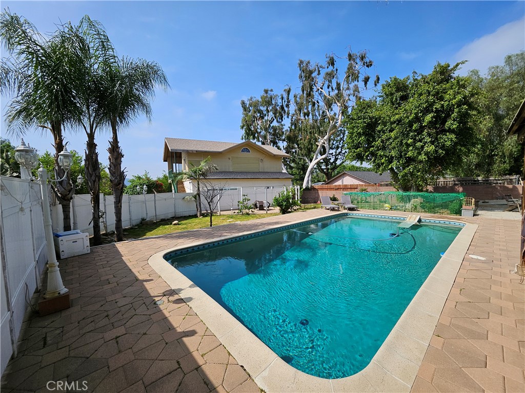 9740 La Canada Way Shadow Hills, CA 91040 - Photo 19 of 28 a view of a swimming pool with a garden