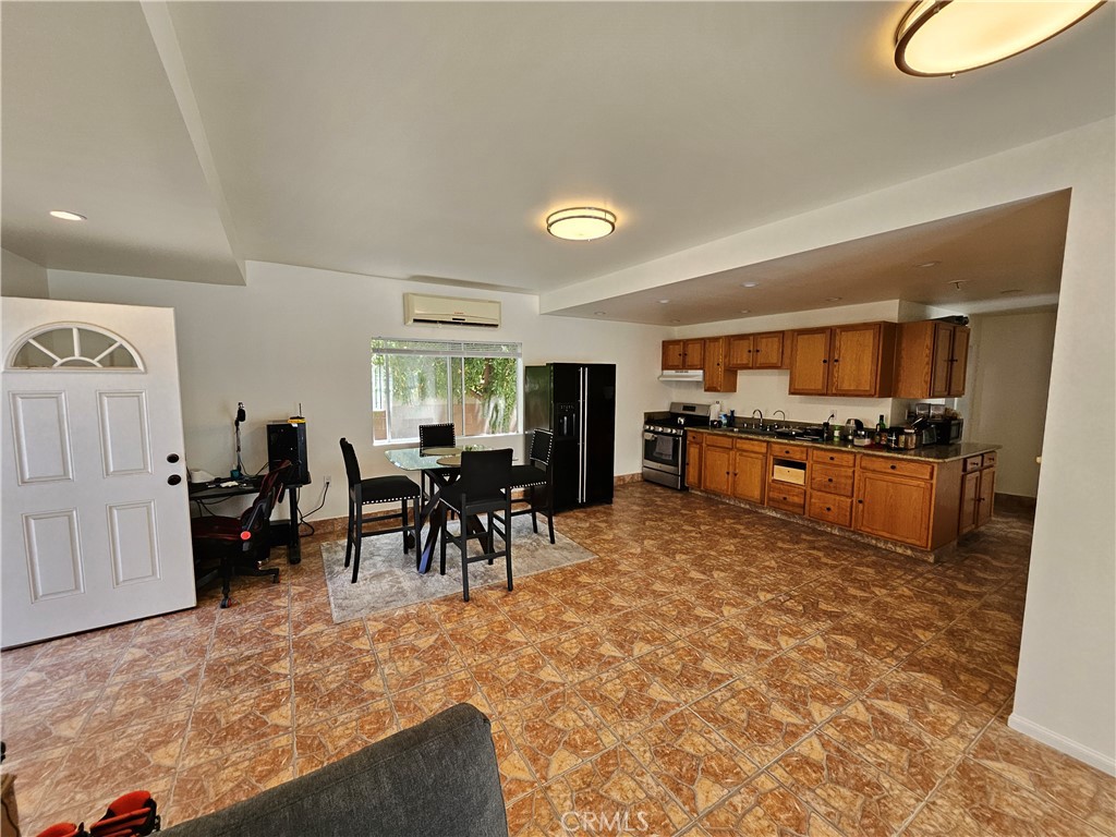 9740 La Canada Way Shadow Hills, CA 91040 - Photo 25 of 28 a living room with furniture a dining table and kitchen view