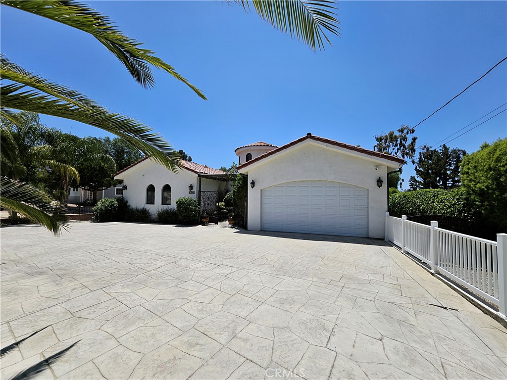 9740 La Canada Way Shadow Hills, CA 91040 - Photo 5 of 28 a view of a house with a yard