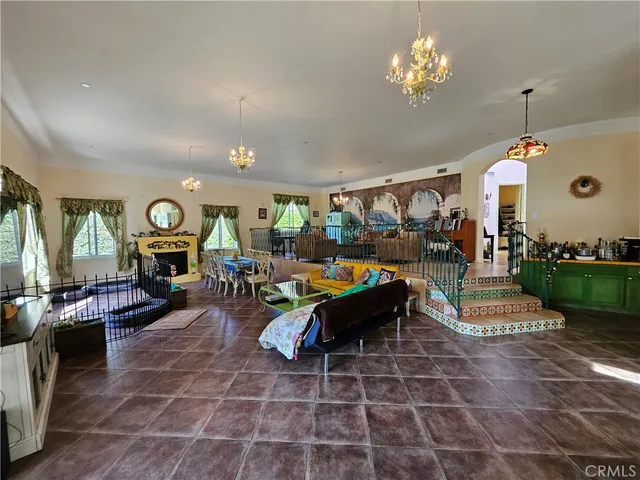 a living room with fireplace furniture and a chandelier