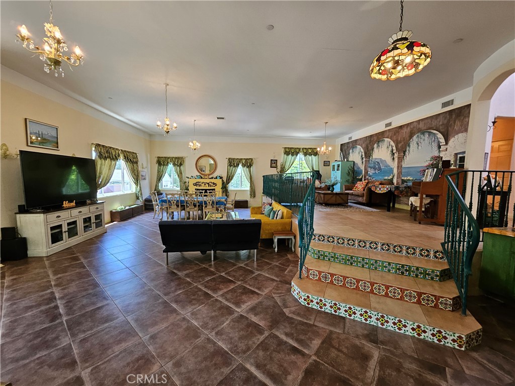 9740 La Canada Way Shadow Hills, CA 91040 - Photo 8 of 28 a living room with furniture a rug and a flat screen tv