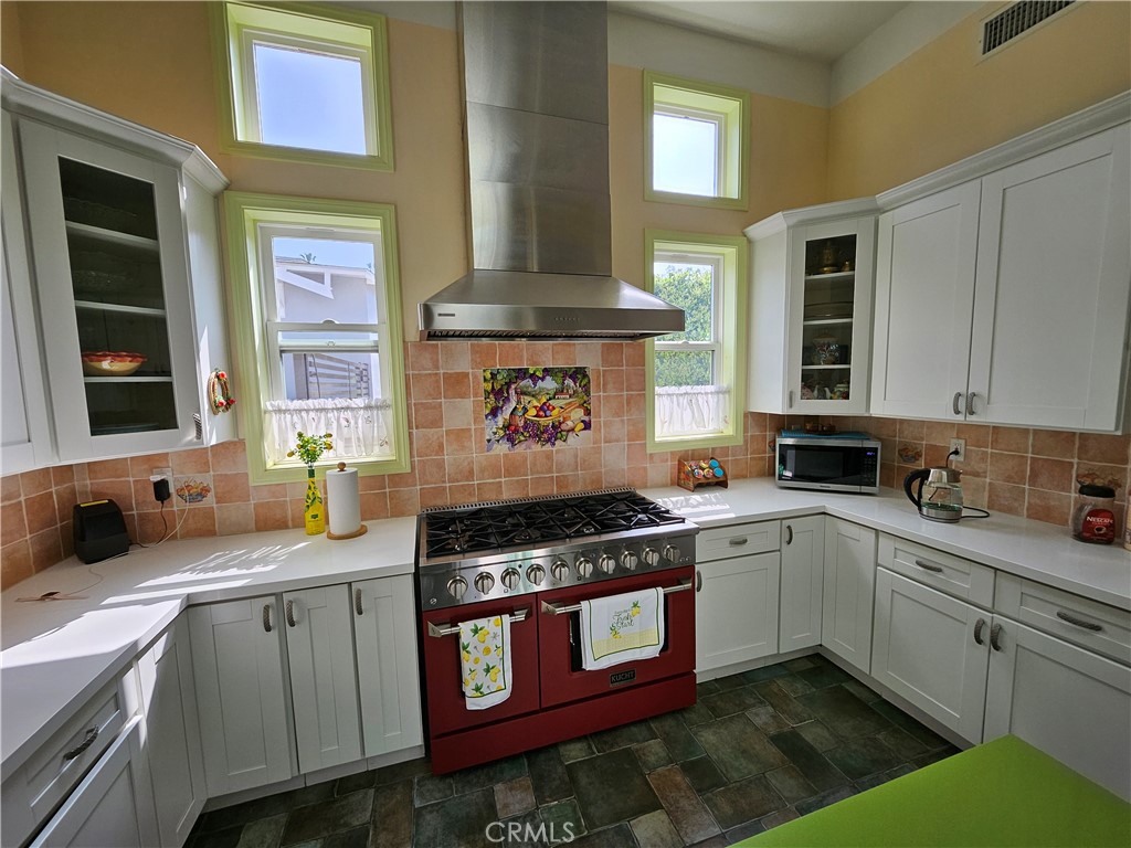 9740 La Canada Way Shadow Hills, CA 91040 - Photo 9 of 28 a kitchen with stainless steel appliances granite countertop a stove a sink and a cabinets
