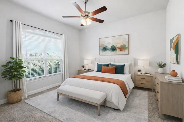 a spacious bedroom with a bed and a painting on the wall