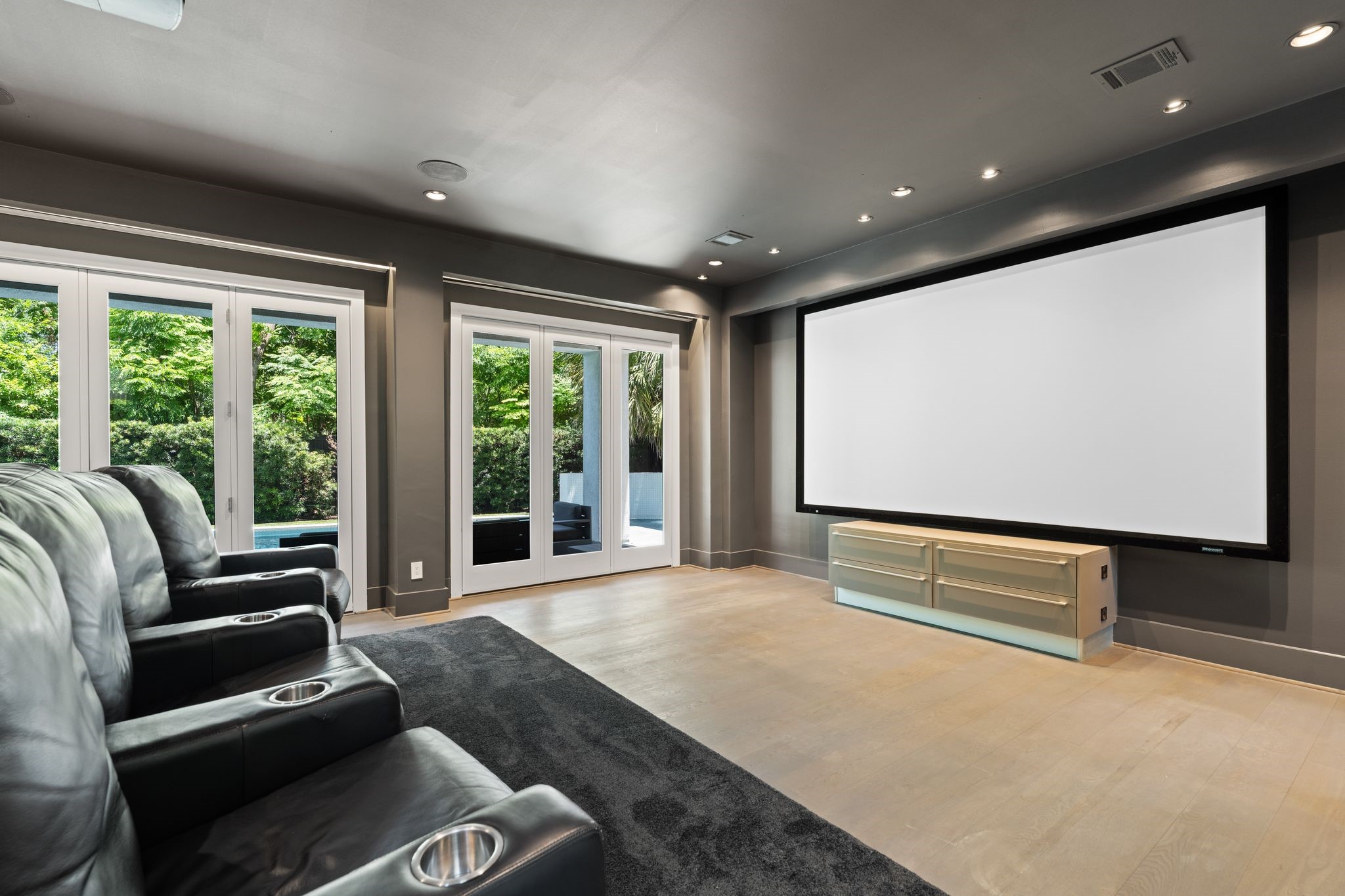 3703 Wroxton Road West University Place, TX 77005 - Photo 18 of 36 Enjoy a true cinematic experience in the dedicated theater room, complete with a large projection screen, surround sound, and direct access to the pool—perfect for movie nights, game days, and entertaining.
