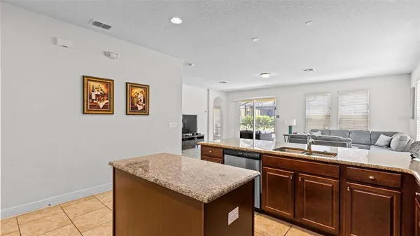 a kitchen with a sink dishwasher and wooden cabinets
