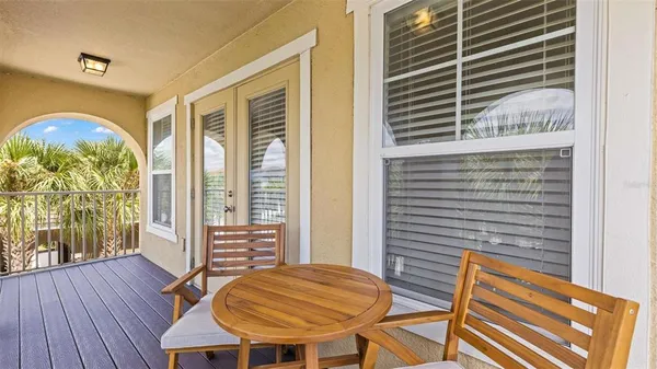 a view of a balcony with table and chairs
