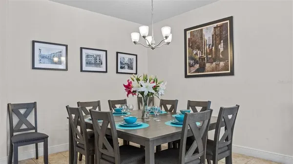 a view of a dining room with furniture and chandelier