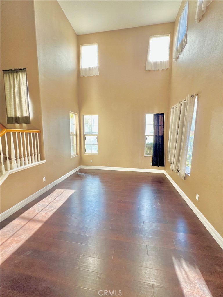 27145 Cherry Grove Court Temecula, CA 92591 - Photo 12 of 61 a view of an empty room with window and wooden floor