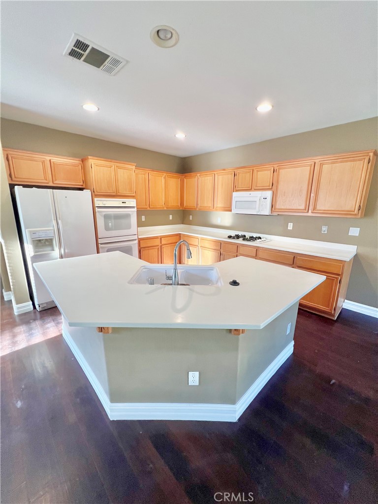 27145 Cherry Grove Court Temecula, CA 92591 - Photo 20 of 61 a view of a kitchen with a sink and wooden floor