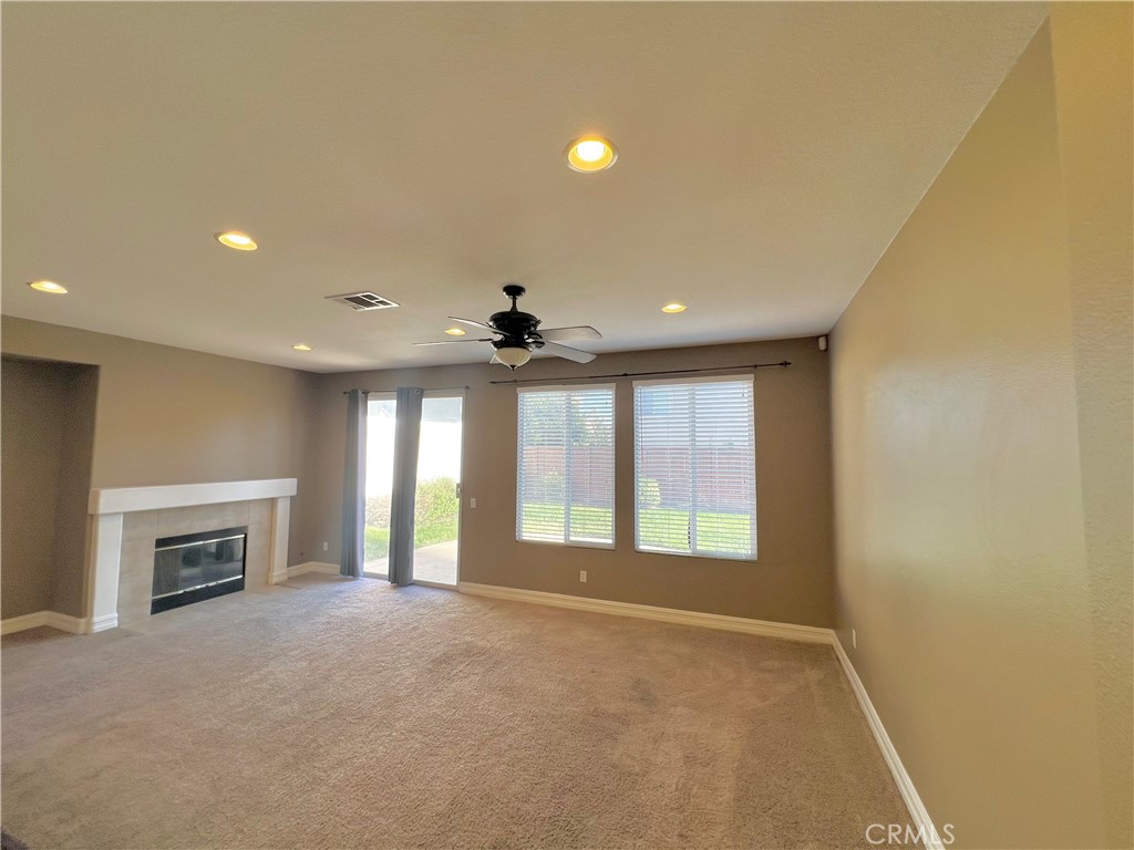 27145 Cherry Grove Court Temecula, CA 92591 - Photo 26 of 61 a view of an empty room with a fireplace and a window