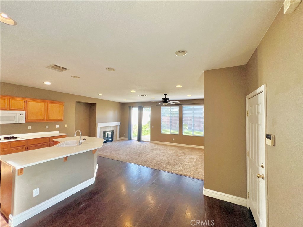 27145 Cherry Grove Court Temecula, CA 92591 - Photo 27 of 61 a open kitchen with a sink stove and wooden floor