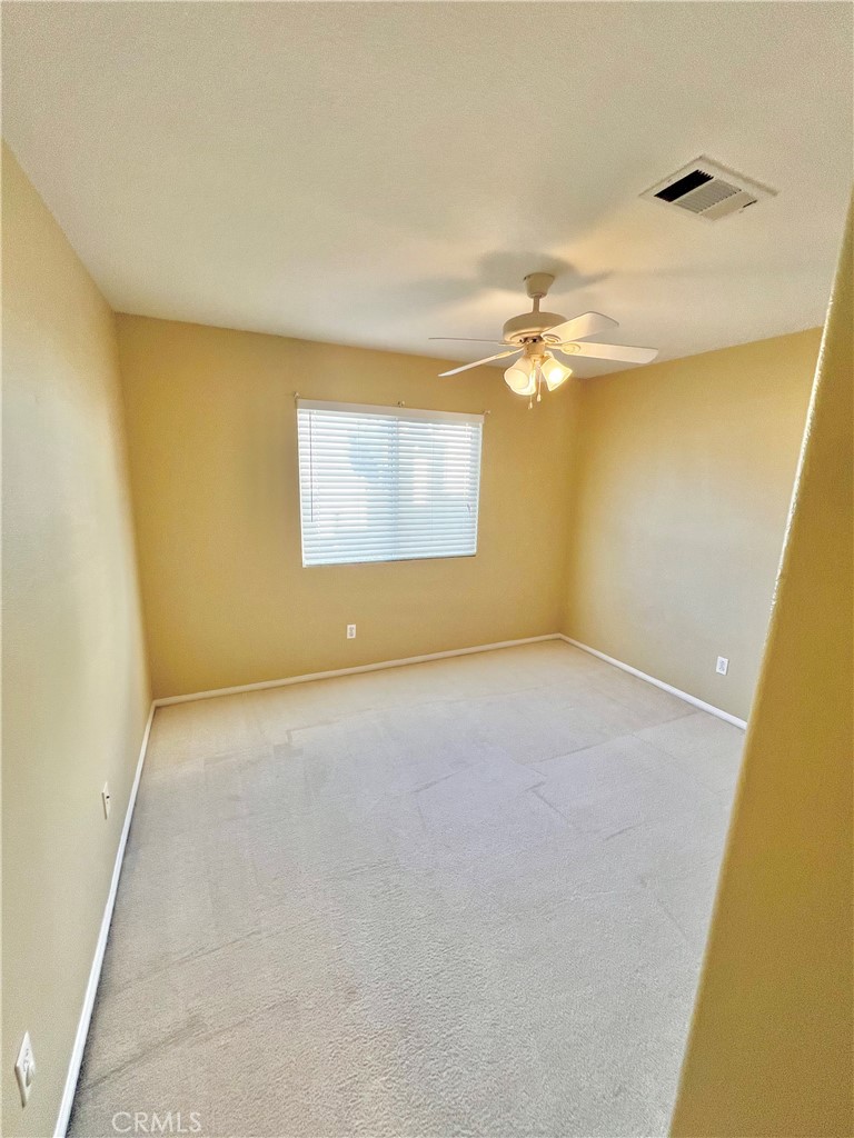 27145 Cherry Grove Court Temecula, CA 92591 - Photo 31 of 61 an empty room with a chandelier fan and windows