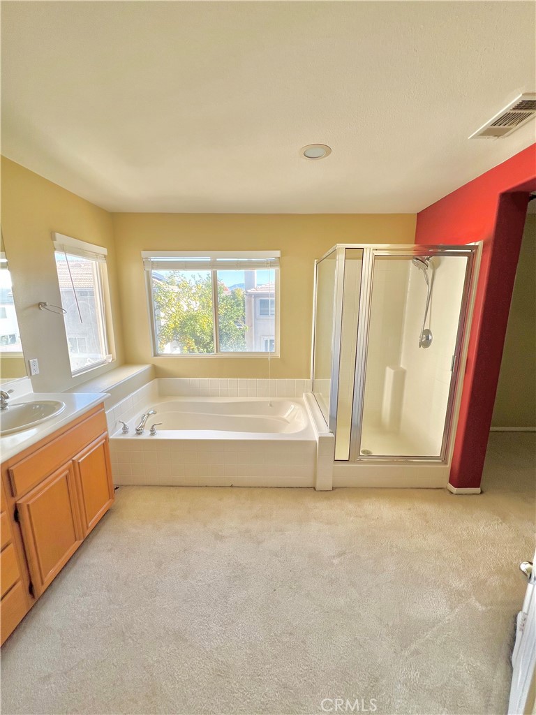 27145 Cherry Grove Court Temecula, CA 92591 - Photo 44 of 61 a spacious bathroom with a tub sink and window