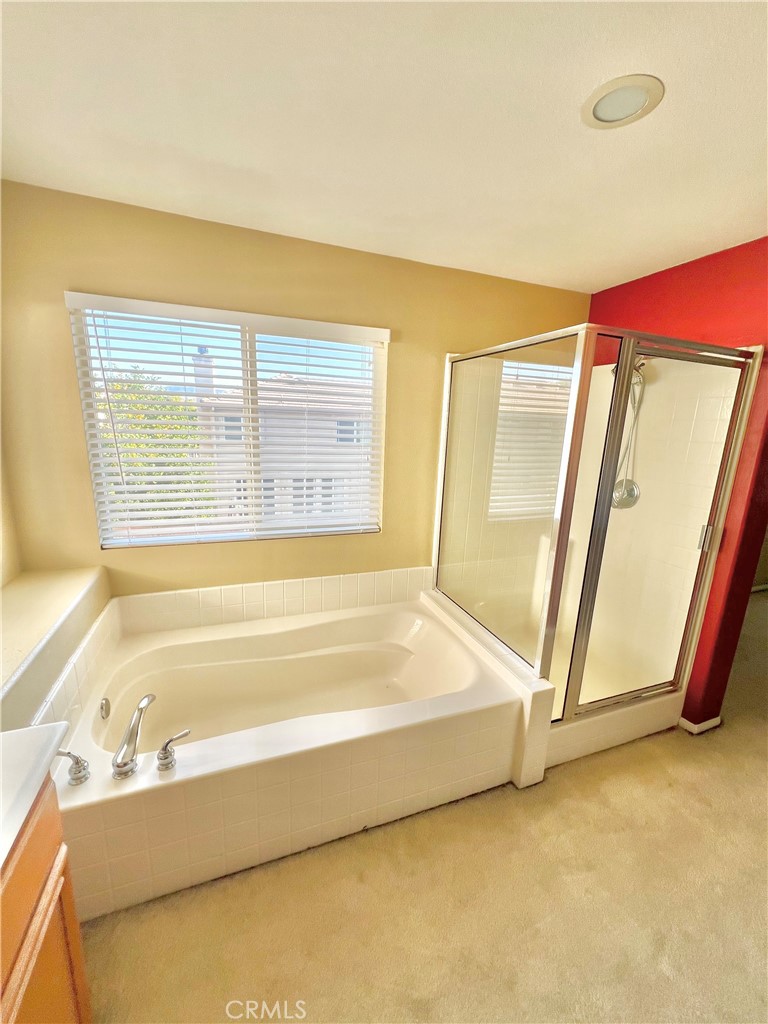 27145 Cherry Grove Court Temecula, CA 92591 - Photo 45 of 61 a bathroom with a tub a sink and a large window