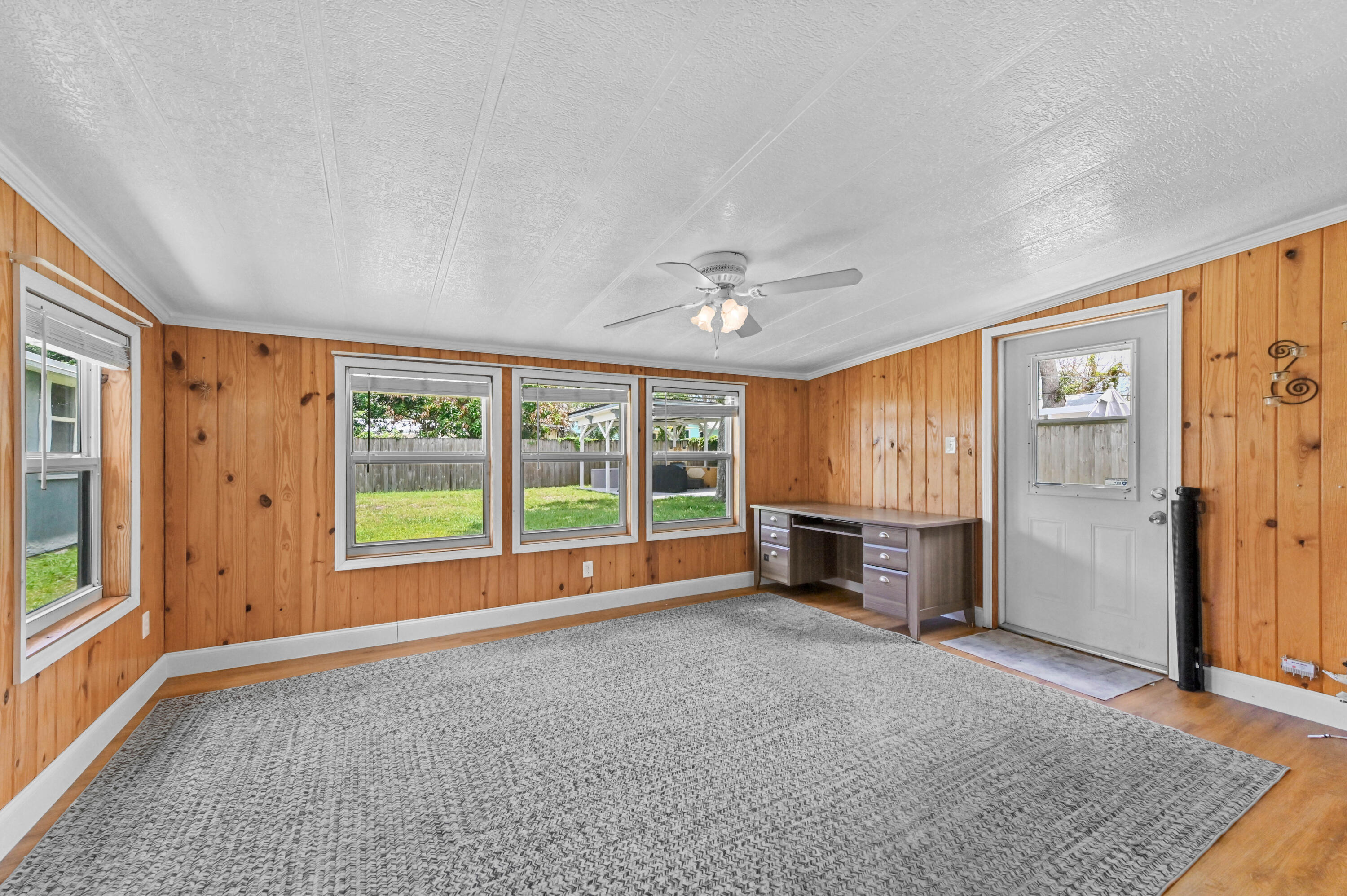 5709 Southeast Indigo Avenue Stuart, FL 34997 - Photo 15 of 26 an empty room with windows and fireplace