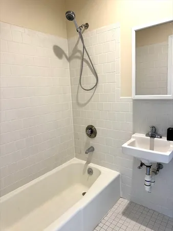 a bathroom with a sink a mirror and a shower