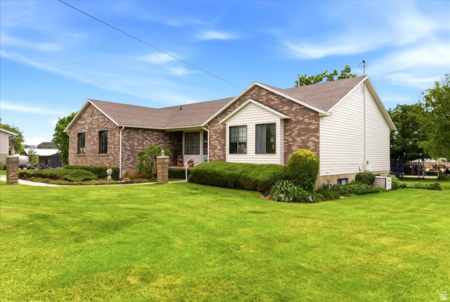 5321 South 3100th Street West Roy, UT 84067 - Photo 56 of 64 Brick and siding exterior with a gabled roofline