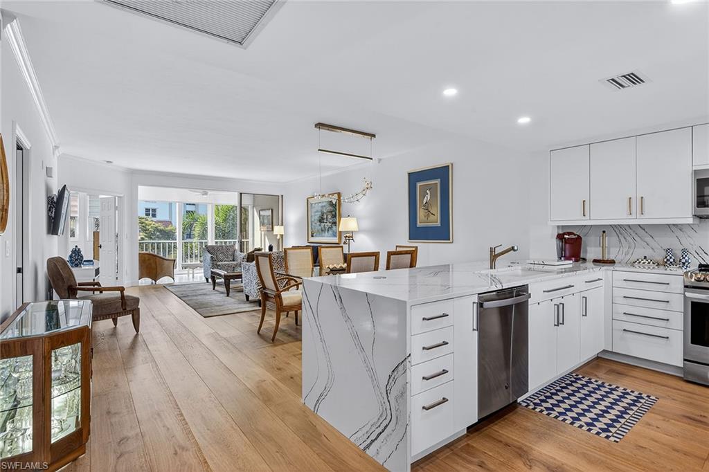 6537 Marissa Loop, Unit 4 Naples, FL 34108 - Photo 3 of 30 a open kitchen with sink cabinets and wooden floor