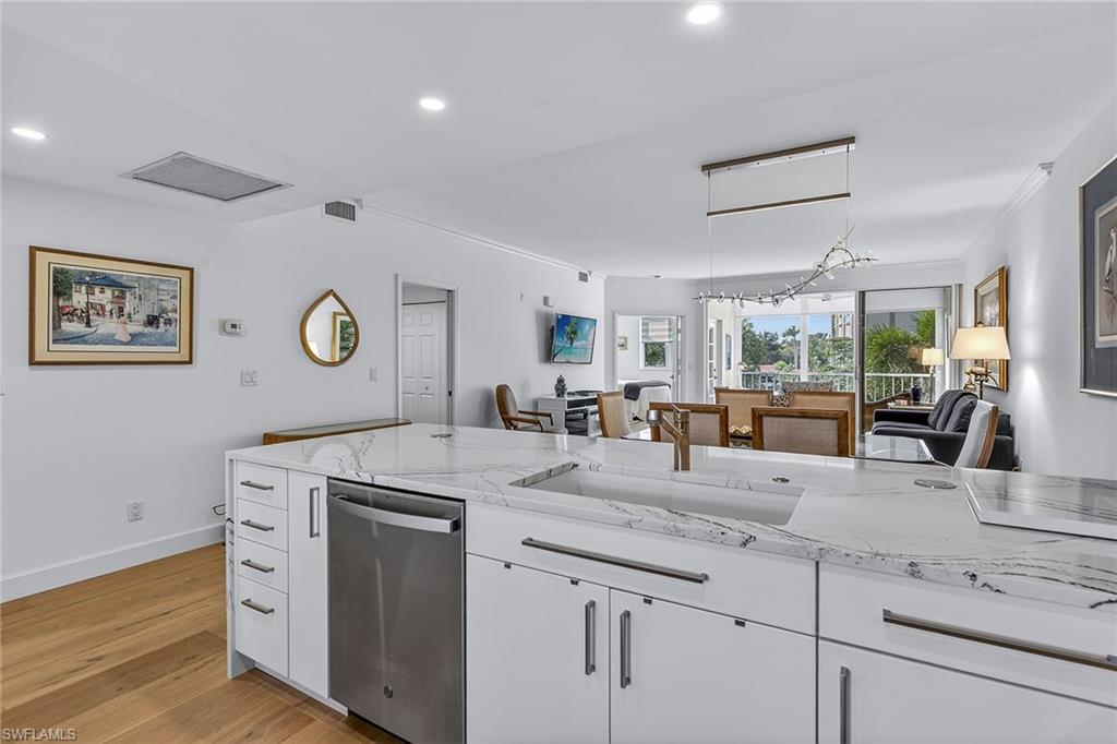6537 Marissa Loop, Unit 4 Naples, FL 34108 - Photo 5 of 30 a view with granite countertop a sink a window stainless steel appliances and cabinets
