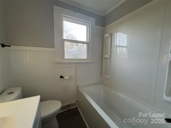 a bathroom with a sink a toilet and bathtub