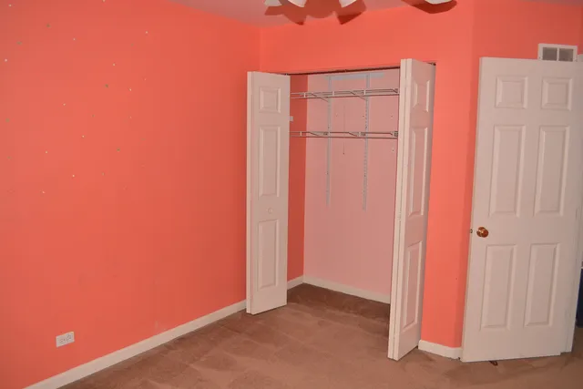 a view of a hallway with wooden shelves