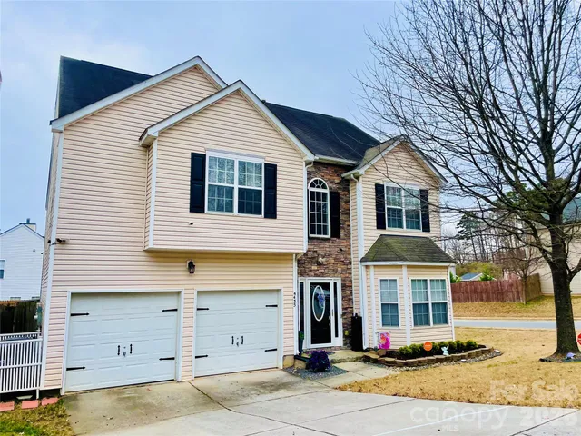 a view of a white house with large windows