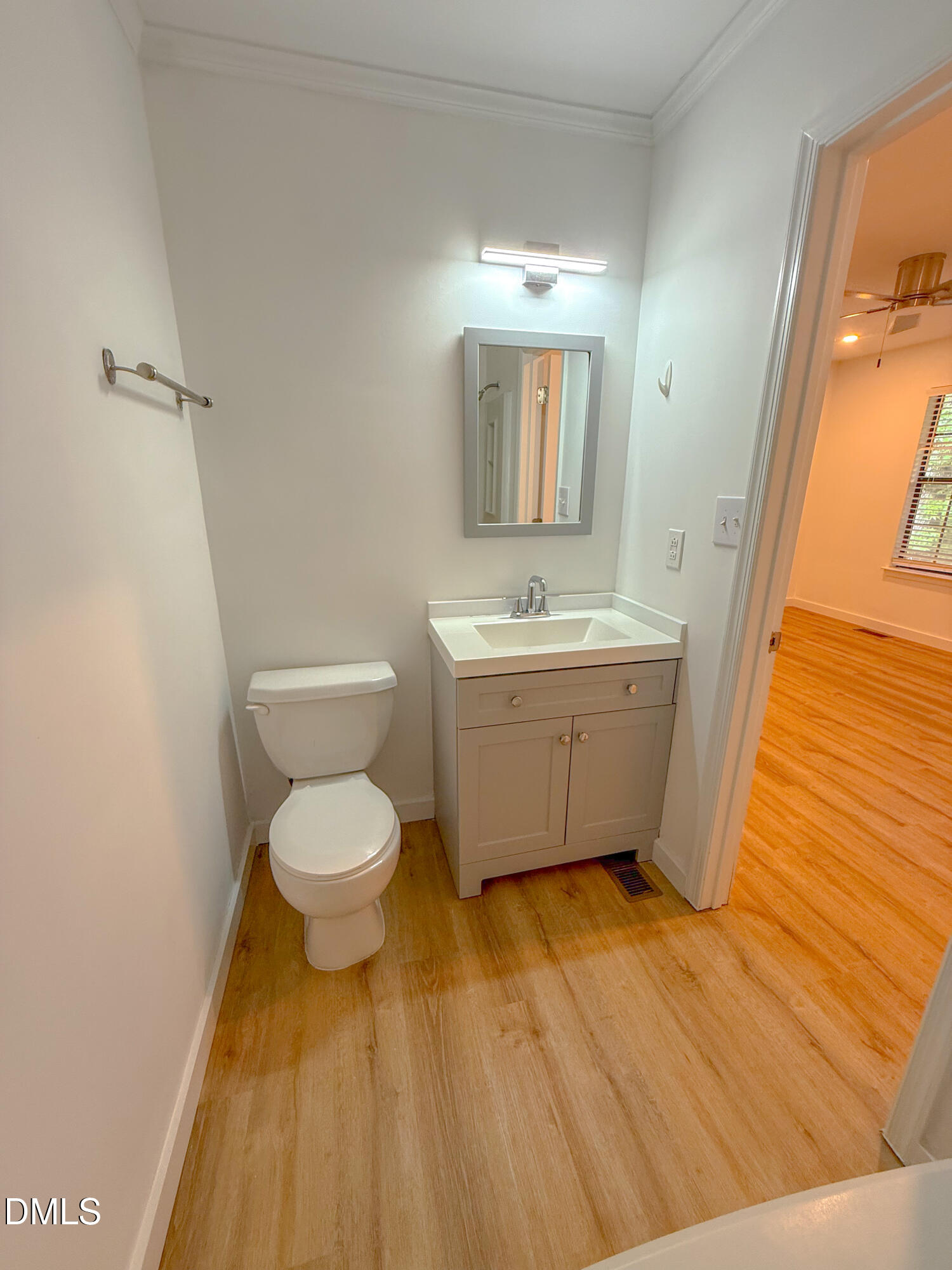 4247 The Oaks Drive Raleigh, NC 27606 - Photo 11 of 21 a bathroom with a toilet a sink and mirror