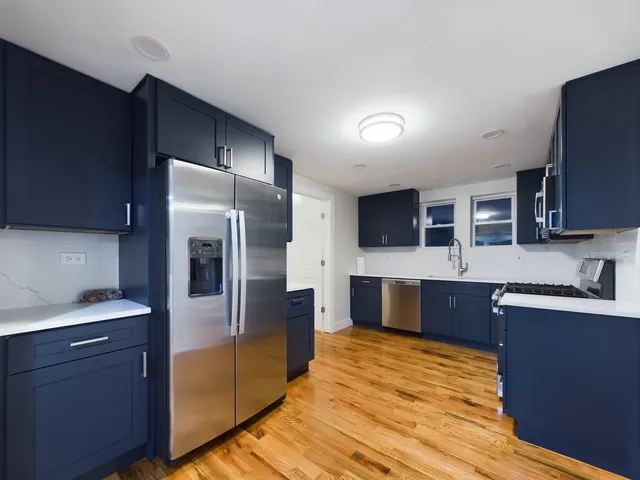 a kitchen with stainless steel appliances wooden cabinets and granite counter tops