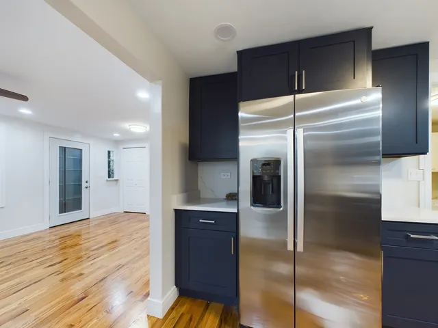 a kitchen with a refrigerator and a sink