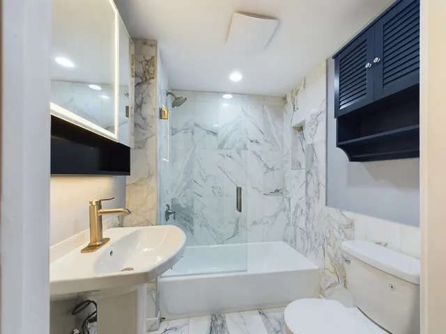 a bathroom with a sink toilet a shower and bathtub