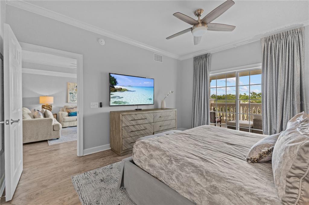 1354 Centre Ct Ridge Drive, Unit 302 Reunion, FL 34747 - Photo 13 of 33 a bedroom with a bed and a chandelier