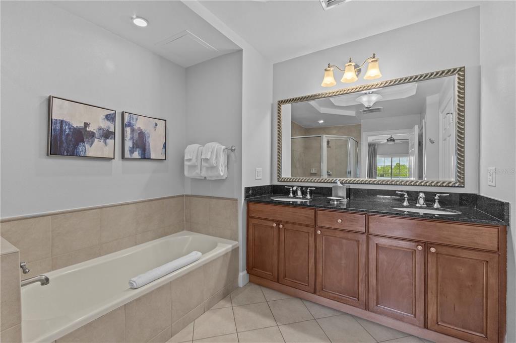 1354 Centre Ct Ridge Drive, Unit 302 Reunion, FL 34747 - Photo 15 of 33 a bathroom with a tub a double vanity sink and a mirror