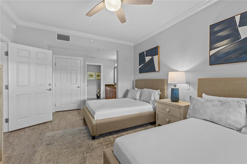 1354 Centre Ct Ridge Drive, Unit 302 Reunion, FL 34747 - Photo 17 of 33 a bedroom with two beds and painting on the wall