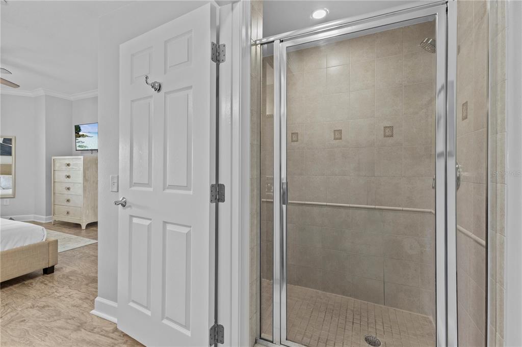 1354 Centre Ct Ridge Drive, Unit 302 Reunion, FL 34747 - Photo 20 of 33 a bathroom with a glass shower door