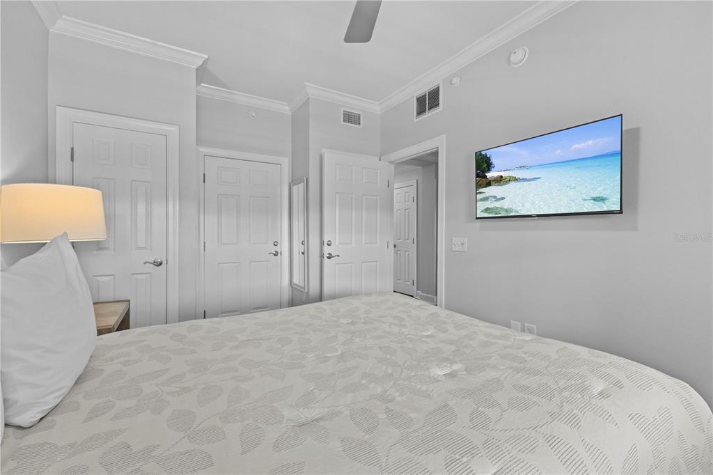 1354 Centre Ct Ridge Drive, Unit 302 Reunion, FL 34747 - Photo 22 of 33 a bedroom with a large bed a rug and painting on the wall