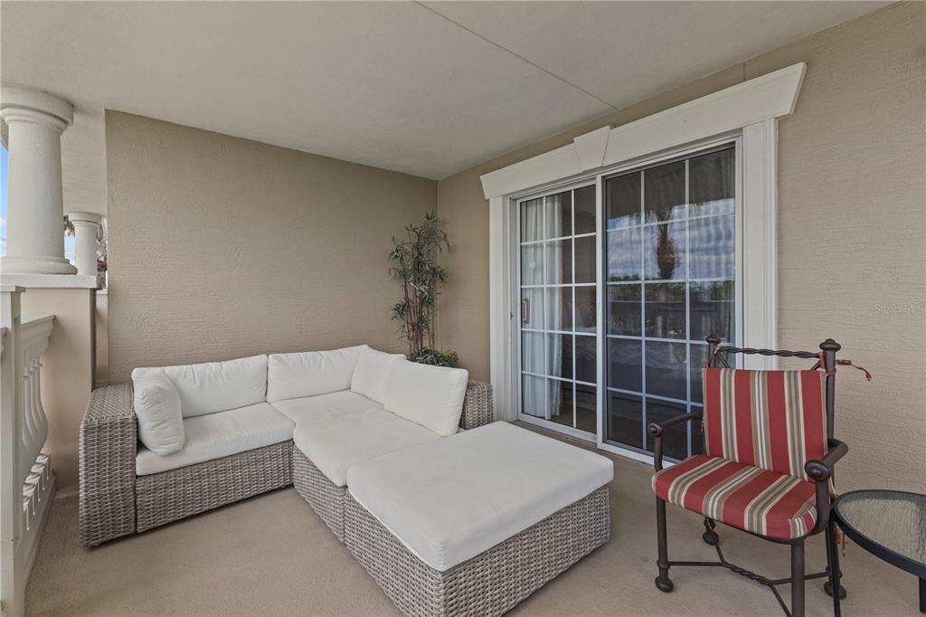 1354 Centre Ct Ridge Drive, Unit 302 Reunion, FL 34747 - Photo 28 of 33 a bedroom with furniture and a large window