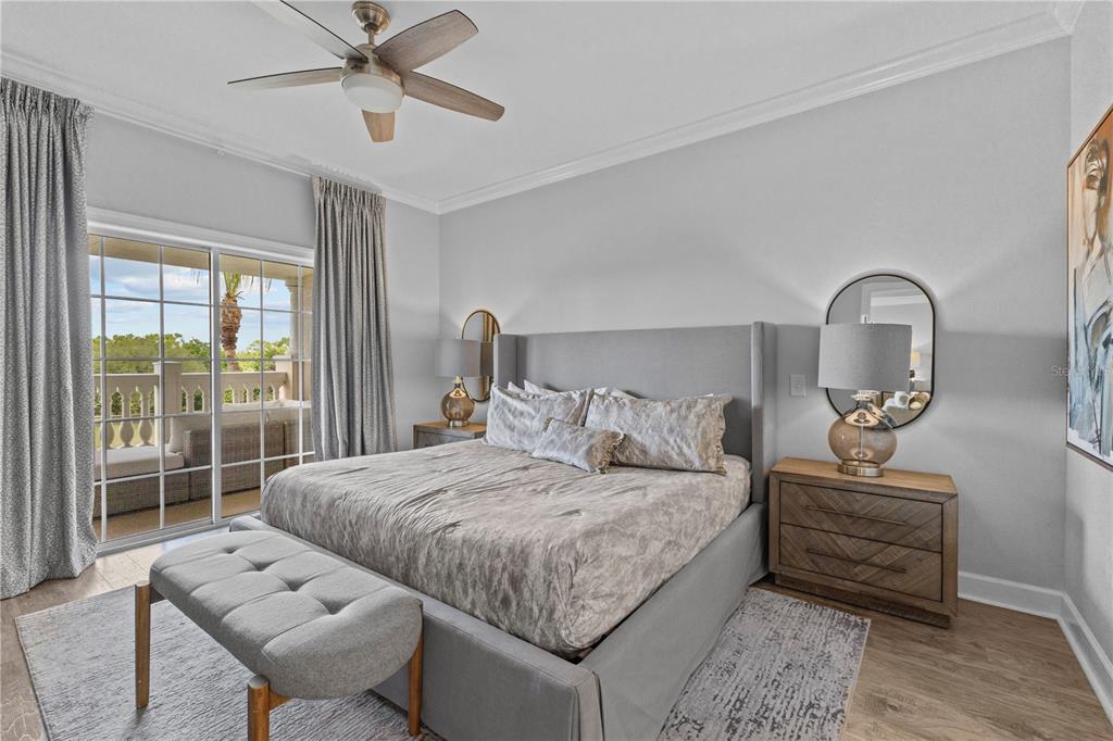 1354 Centre Ct Ridge Drive, Unit 302 Reunion, FL 34747 - Photo 4 of 33 a bedroom with a bed a couch and large window