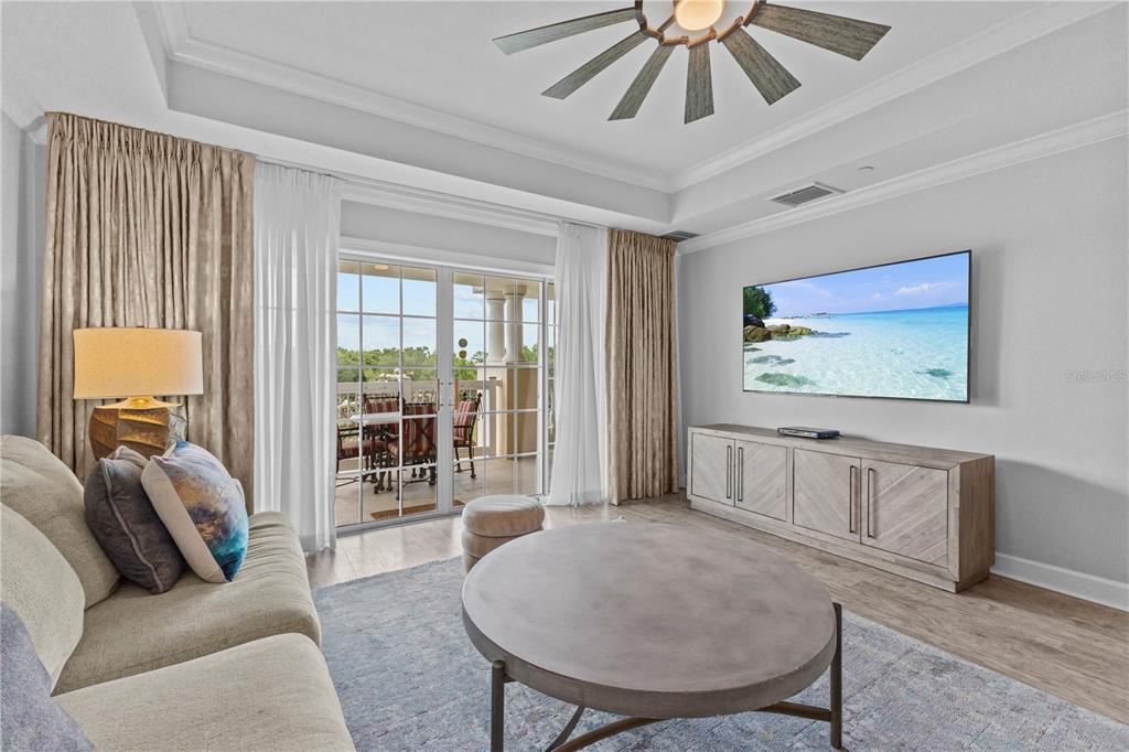 1354 Centre Ct Ridge Drive, Unit 302 Reunion, FL 34747 - Photo 7 of 33 a living room with furniture a large window and a chandelier