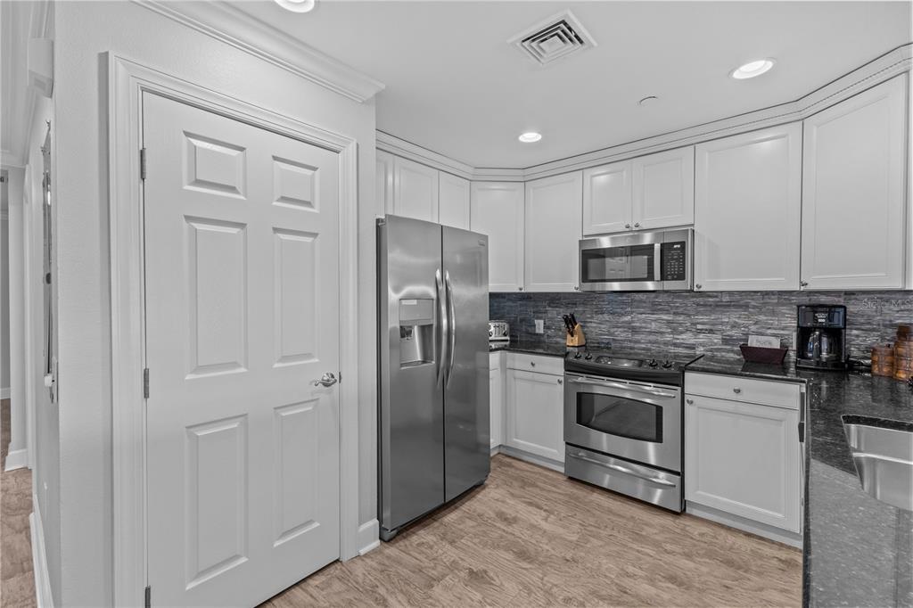 1354 Centre Ct Ridge Drive, Unit 302 Reunion, FL 34747 - Photo 9 of 33 a kitchen with cabinets stainless steel appliances and sink