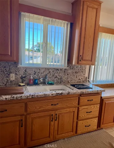 a kitchen with stainless steel appliances granite countertop a sink a stove and a microwave