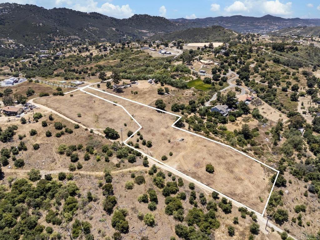 15626 Mathew Road Valley Center, CA 92082 - Photo 1 of 8 an aerial view of residential house and sandy dunes