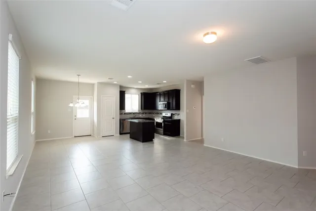 a view of kitchen with refrigerator sink and stove