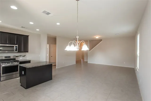a view of a kitchen with microwave and cabinets