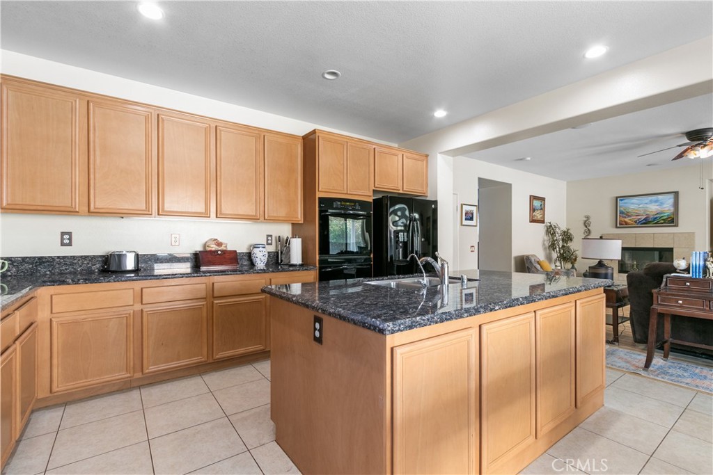 37192 High Ridge Drive Beaumont, CA 92223 - Photo 11 of 71 a kitchen with stainless steel appliances granite countertop a sink counter space cabinets and a view of living room