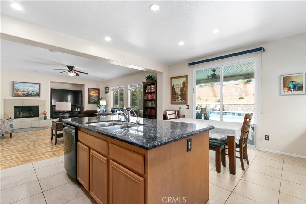 37192 High Ridge Drive Beaumont, CA 92223 - Photo 13 of 71 a kitchen with stainless steel appliances granite countertop table chairs and a view of living room