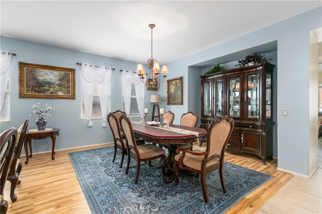 37192 High Ridge Drive Beaumont, CA 92223 - Photo 17 of 71 a dining room with furniture a chandelier and wooden floor